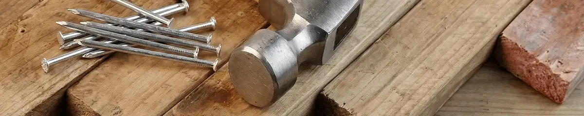 Hammer and nails on hardwood flooring boards in Fort Wayne, IN
